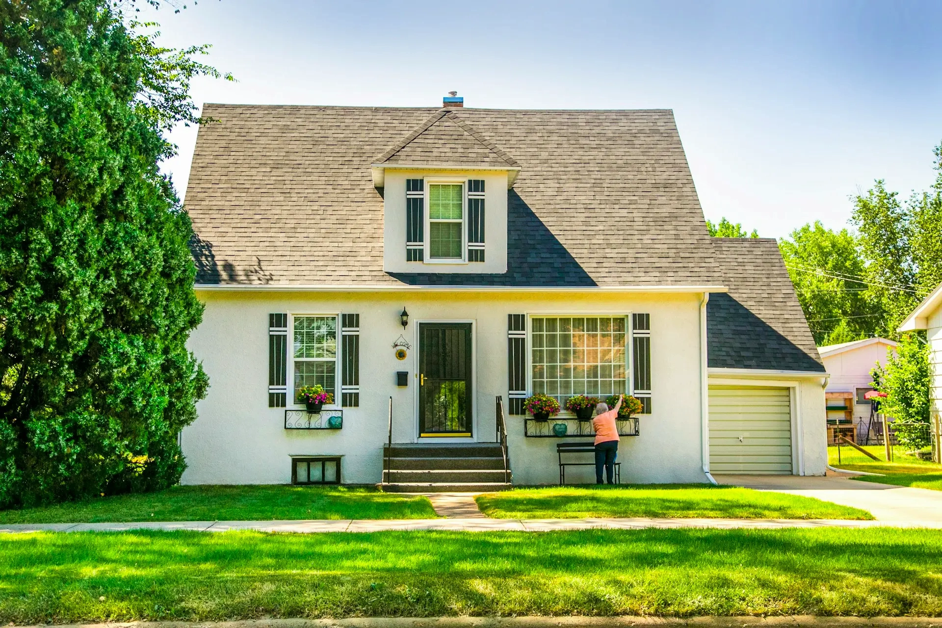Suburban home with flowers and green lawn